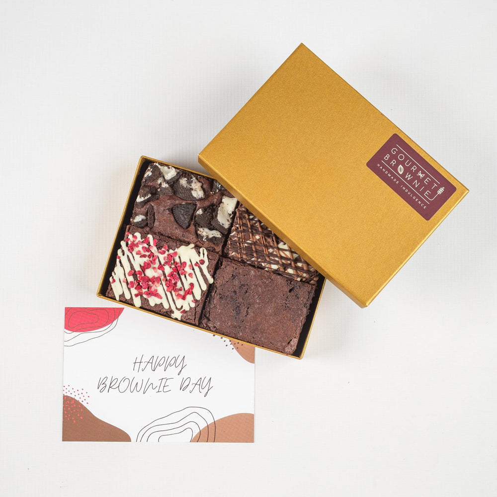 
                  
                    Load image into Gallery viewer, Small chocolate brownie gift box showing four slices of brownie.  Each a different flavour and topped with different ingredients or chocolate drizzle.  &amp;#39;Happy Brownie Day&amp;#39; gift card under box of brownies.
                  
                
